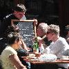 Calvin Klein and friends ordering food at Bar Pitti New York City.