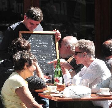 Calvin Klein and friends ordering food at Bar Pitti New York City.