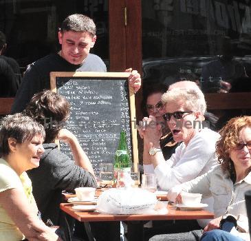 Calvin Klein and friends ordering food at Bar Pitti New York City.