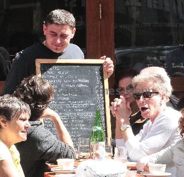 Calvin Klein and friends ordering food at Bar Pitti New York City.