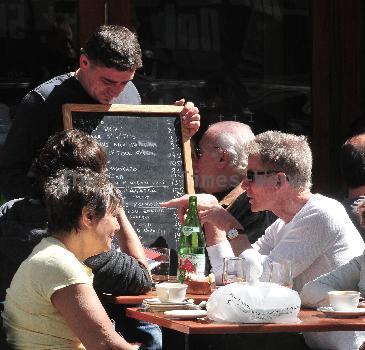 Calvin Klein and friends ordering food at Bar Pitti New York City.