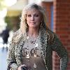 Morgan Fairchild 
walking in Beverly Hills wearing a long gold necklace
Los Angeles, California.