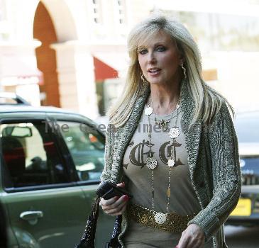 Morgan Fairchild 
walking in Beverly Hills wearing a long gold necklace
Los Angeles, California.