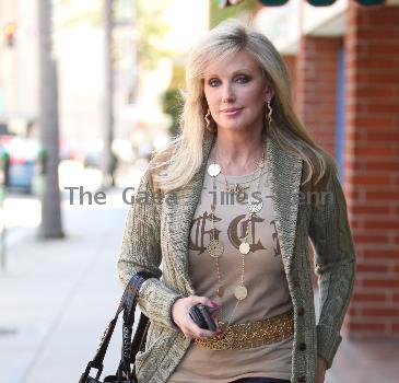 Morgan Fairchild 
walking in Beverly Hills wearing a long gold necklace
Los Angeles, California.