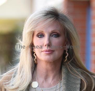 Morgan Fairchild 
walking in Beverly Hills wearing a long gold necklace
Los Angeles, California.