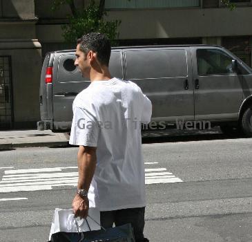 New York Yankees catcher Jorge Posada catches a cab after shopping at Chanel on Madison Avenue New York City.