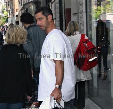 New York Yankees catcher Jorge Posada catches a cab after shopping at Chanel on Madison Avenue New York City.