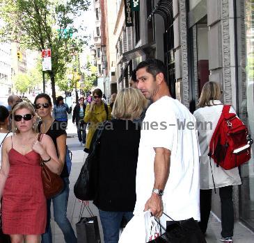 New York Yankees catcher Jorge Posada catches a cab after shopping at Chanel on Madison Avenue New York City.