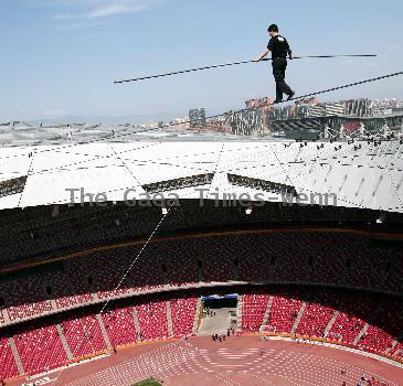 AHDILI LIVES THE HIGH-WIRE LIFE Thrill-seeker Ahdili gingerly crosses a tightrope high above China's famous Bird's Nest – as he bids to spend 60 days living in a tiny cabin on the roof.  Daredevil Ahdili, hailed as the Prince of Tightrope Walking in his native country, crossed from one side of the Beijing National Stadium to the other as nervous onlookers watched from below.  He is planning a feat of endurance – by living in a nine-metre box on top of the arena for the next two months to set a new world record. (ZN/WN)