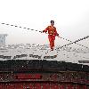 AHDILI LIVES THE HIGH-WIRE LIFE Thrill-seeker Ahdili gingerly crosses a tightrope high above China's famous Bird's Nest – as he bids to spend 60 days living in a tiny cabin on the roof.  Daredevil Ahdili, hailed as the Prince of Tightrope Walking in his native country, crossed from one side of the Beijing National Stadium to the other as nervous onlookers watched from below.  He is planning a feat of endurance – by living in a nine-metre box on top of the arena for the next two months to set a new world record. (ZN/WN)