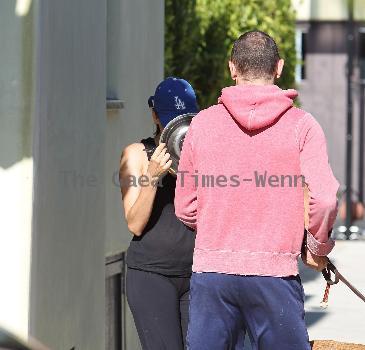 Eva Mendez leaves a gym in West Hollywood by walking out backwards then covering her face with a dog bowl to hide form the photographersLos Angeles.