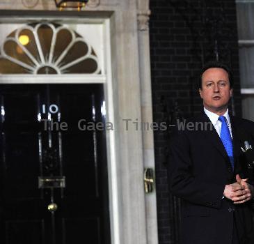 CAMERON APPOINTED NEW BRITISH PRIME MINISTER
 DAVID CAMERON has been appointed Britain's new Prime Minister following the resignation of GORDON BROWN.
  The 43 year old becomes the youngest British leader in over 200 years.
  Cameron's Conservative Party won the most seats in last week's (ends07May10) general election, but not an overall majority.
  Outside his new Downing Street home in London moments ago, Cameron confirmed he has reached an agreement to form a coalition with the Liberal Democrats leader Nick Clegg.
  Cameron's appointment, following a Tuesday morning (11May10) meeting with Queen Elizabeth II, will bring new life to Downing Street - the politician and his wife Samantha are expecting their third child in September (10).  

David Cameron arrives at 10 Downing Street with his family.
London, England.