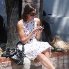 Camilla Belle taking a rest, sitting on a brick wall with her mobile phone in West Hollywood. Los Angeles, California.