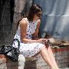 Camilla Belle taking a rest, sitting on a brick wall with her mobile phone in West Hollywood. Los Angeles, California.