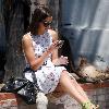 Camilla Belle taking a rest, sitting on a brick wall with her mobile phone in West Hollywood. Los Angeles, California.