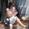 Camilla Belle taking a rest, sitting on a brick wall with her mobile phone in West Hollywood. Los Angeles, California.