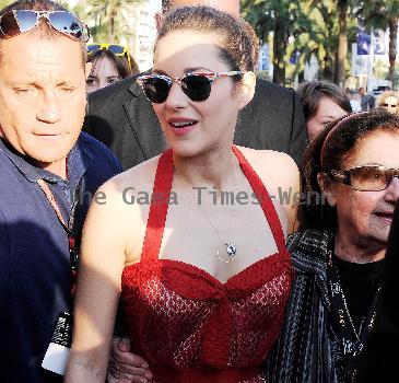 Marion Cotillardis escorted by bodyguards as she walks along the Croisette during the 63rd Cannes Film FestivalCannes.