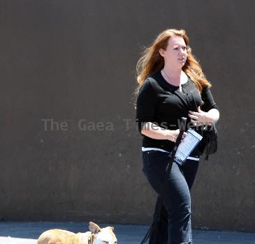 An assistant of David Beckham seen walking his pet dog Coco as Beckham took his children to the Skatelab indoor skate park in Simi Valley.Los Angeles.