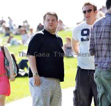 James Corden and Julia Carey
embrace while spending an afternoon relaxing with friends in Primrose Hill park
London, England.