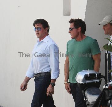 Sylvester Stallone 
signs an autograph for a fan while out and about in Beverly Hills smoking a cigar.
Los Angeles, California, USA.