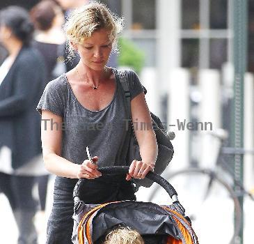 Gretchen Mol pushing her son, Ptolemy John Williams, in a stroller while out and about in SoHo New York City.