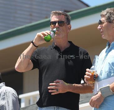 BEERS BROSNAN Former James Bond star Pierce Brosnan indulges in a cold beer on a sunny day in Malibu. The actor, immortalised as the trim superspy in 007 films including Die Another Day, is snapped holding his hand over what appears to be a bulging belly.Los Angeles.