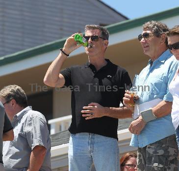 BEERS BROSNAN Former James Bond star Pierce Brosnan indulges in a cold beer on a sunny day in Malibu. The actor, immortalised as the trim superspy in 007 films including Die Another Day, is snapped holding his hand over what appears to be a bulging belly.Los Angeles.