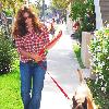 Eva Mendes, wearing plaid and jeans, walking her dog in Beverly Hills Los Angeles.