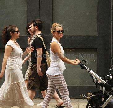 Kate Hudson walking with a friends baby on the way to Giggles baby store in Soho New York.