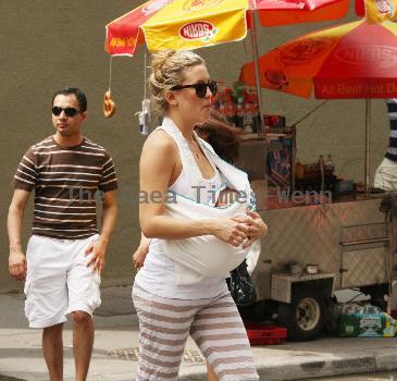 Kate Hudson walking with a friends baby on the way to Giggles baby store in Soho New York.