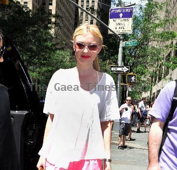 Dakota Fanning out and about in Rockefeller Center New York City.