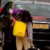 Konnie Huq The former Blue Peter presenter is the new host of ITV2's spin off show The Xtra Factor. Konnie with her hands full, carrying a suitcase, yellow selfridges bag, a bouquet of flowers, returns home from Glasgow, where auditions have begun. London.