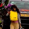 Konnie Huq The former Blue Peter presenter is the new host of ITV2's spin off show The Xtra Factor. Konnie with her hands full, carrying a suitcase, yellow selfridges bag, a bouquet of flowers, returns home from Glasgow, where auditions have begun. London.