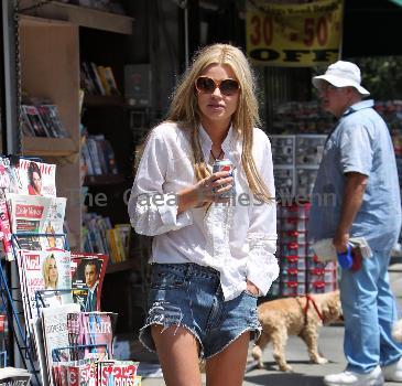 Sophie Monkhas breakfast at Kings Road Cafe wearing cut off denim shorts that appear a few sizes too large. Los Angeles.