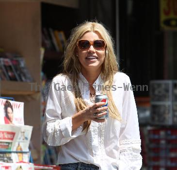 Sophie Monkhas breakfast at Kings Road Cafe wearing cut off denim shorts that appear a few sizes too large. Los Angeles.