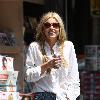 Sophie Monkhas breakfast at Kings Road Cafe wearing cut off denim shorts that appear a few sizes too large. Los Angeles.