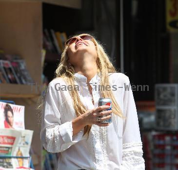 Sophie Monkhas breakfast at Kings Road Cafe wearing cut off denim shorts that appear a few sizes too large. Los Angeles.