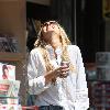 Sophie Monkhas breakfast at Kings Road Cafe wearing cut off denim shorts that appear a few sizes too large. Los Angeles.