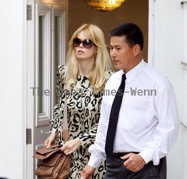 Claudia Schiffer leaving home to head for Luton airport London.