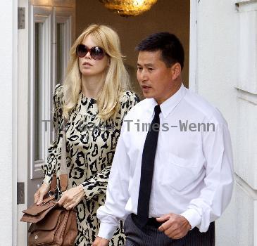 Claudia Schiffer leaving home to head for Luton airport London.