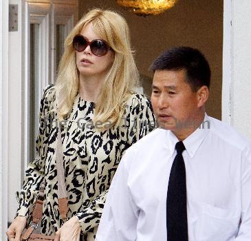 Claudia Schiffer leaving home to head for Luton airport London.