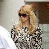 Claudia Schiffer leaving home to head for Luton airport London.