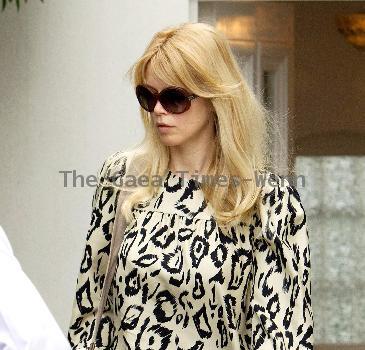 Claudia Schiffer leaving home to head for Luton airport London.