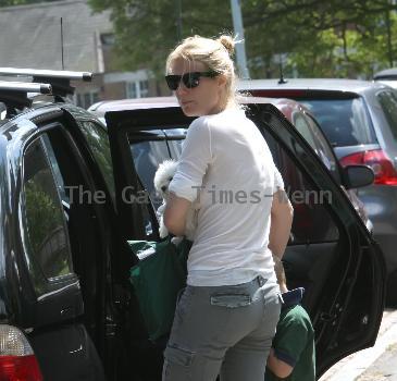 Gwyneth Paltrow carrying her dog outside her son's school London.