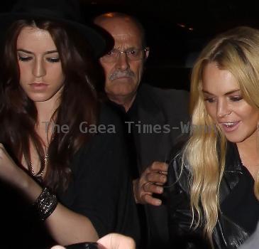 Lindsay Lohan leaving Teddy's nightclub in Hollywood, wearing a striped dress and leather jacket. Los Angeles, California.