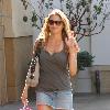 Estella Warren shopping at The Grove in Hollywood wearing a short denim skirt. Los Angeles, California.