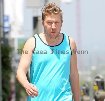 Nick Swardson actor and comedian walking down Melrose Avenue wearing a tank top Los Angeles.