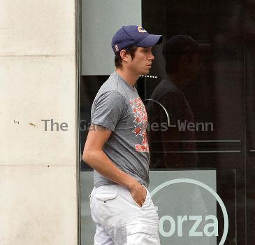 Vernon Kay arrives at the BBC Radio 1 studios to present his weekend show, wearing a Chicago Bears cap and t-shirt, white shorts and flip flops. 
London, England.