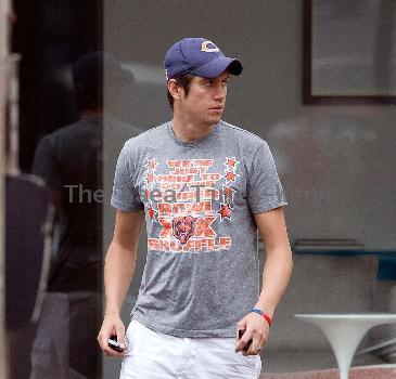 Vernon Kay arrives at the BBC Radio 1 studios to present his weekend show, wearing a Chicago Bears cap and t-shirt, white shorts and flip flops. 
London, England.