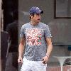 Vernon Kay arrives at the BBC Radio 1 studios to present his weekend show, wearing a Chicago Bears cap and t-shirt, white shorts and flip flops. 
London, England.